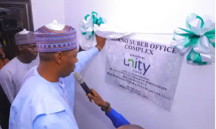 Borno State Governor, Prof. Babagana Umara Zulum inspecting the plaque during the official commissioning of the SUBEB building donated by Unity Bank