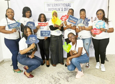 Some female staff pose for a photo at Unity Bank HQ in Lagos in commemoration of the International Women's Day 2022 celebration