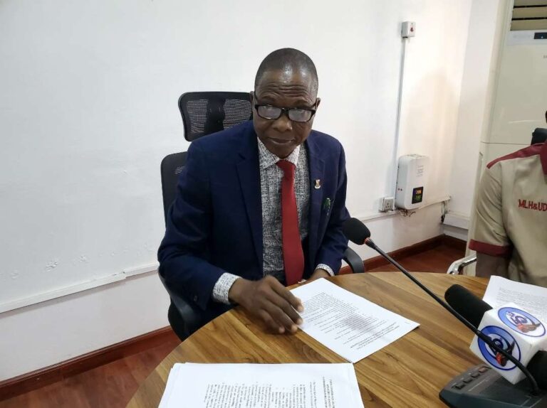 Commissioner for lands, housing and Urban Development addressing pressmen