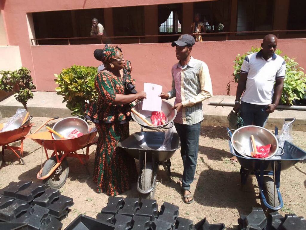 Oyo State coordinator, Mrs Olayinka Olayemi, presenting EBTS empowerment tool to one of the 26 beneficiaries in Oyo State