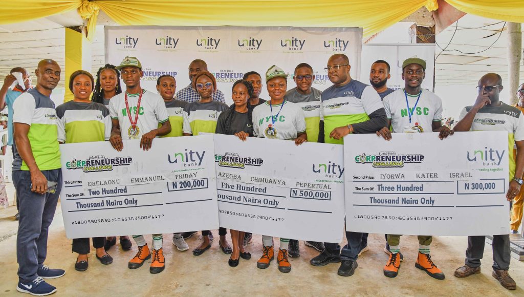 Winners of the Corpreneurship Challenge in Akwa Ibom NYSC camp pose for a photo with some members of the Unity Bank team.