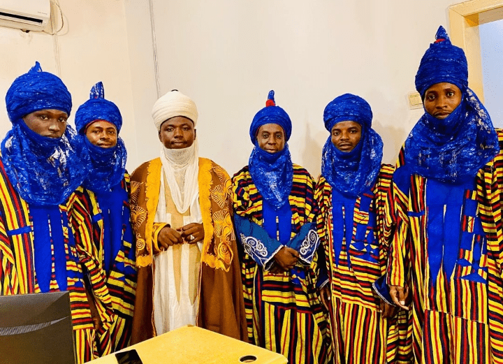 A team dorns traditional attire to celebrate